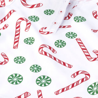 Christmas-themed fabric with candy canes and peppermints on a white background