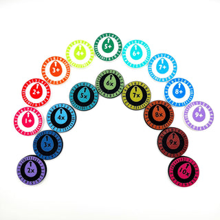 Set of colorful circular tokens with numbers and symbols on a white background