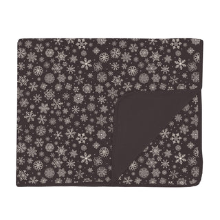 Toddler sized, snowflake patterned blanket with a dark background