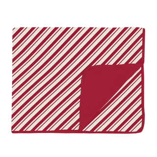 Folded red and white striped blanket on a white background