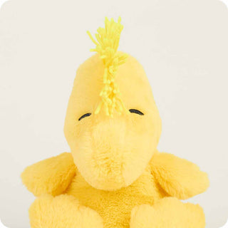 Yellow plush toy with a mohawk on a white background
