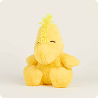 Yellow plush toy with spiky hair on a white background