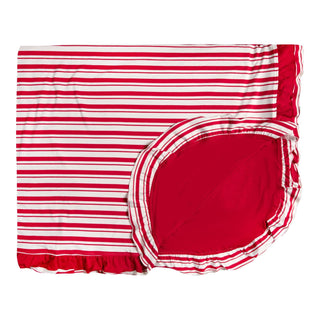 Red and white striped blanket with a ruffled edge on a white background