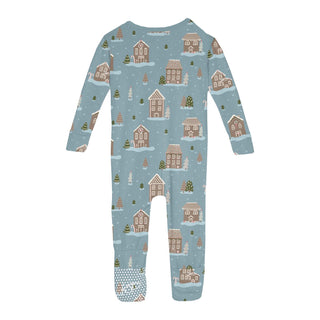 Children's onesie with winter village pattern on a light blue background