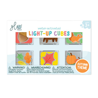 Packaging of water-activated light-up cubes with autumn-themed designs on a white background.