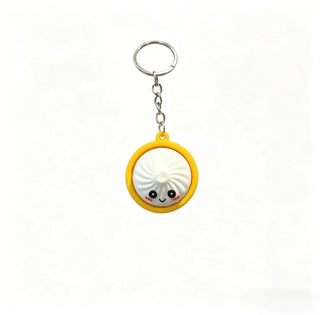 Dumpling keychain with a cute face design on a white background