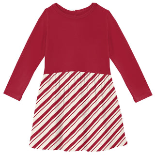 Red long-sleeve top and striped skirt on a white background
