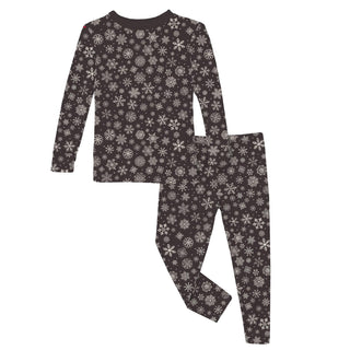 Children's pajama set with snowflake pattern on a white background