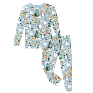 Children's pajama set with winter animal pattern on a light blue background