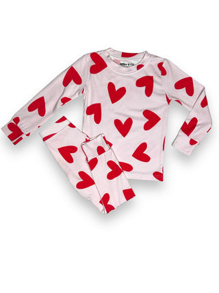 Adult's pajama set with red heart patterns on a white background