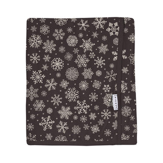 Black blanket with white snowflake pattern on a white background
