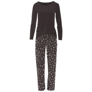 Black long-sleeve top and snowflake patterned pants on a white background