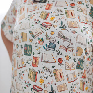 Patterned fabric with books and flowers on a light background