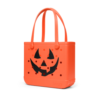 Orange tote bag with a black jack-o'-lantern face design on a white background
