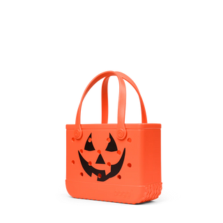 Orange Halloween candy bag with a jack o lantern design on a white background