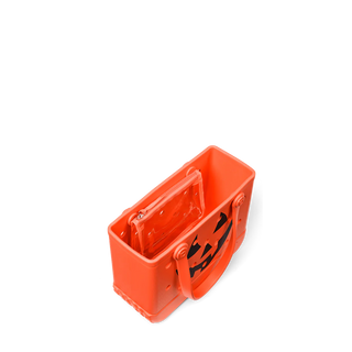Orange jack o lantern themed tote with a black face on a white background