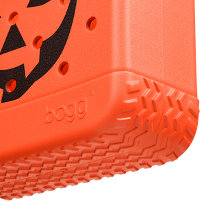 Close-up of an orange tote sole with a textured pattern and 'bogg' branding on a white background.