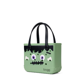 Green bag with a cartoonish monster face design on a white background