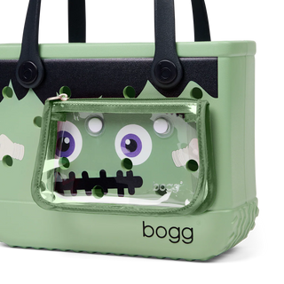Green monster-themed bag with transparent front pocket on a white background