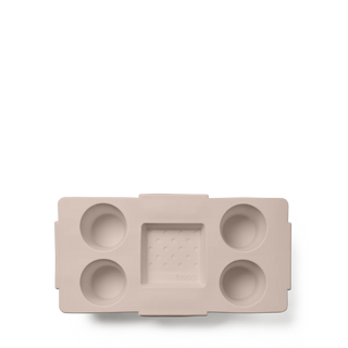 Beige silicone mold with multiple compartments on a white background