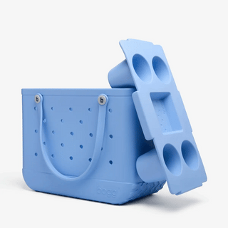 Blue tote with a handle and blue snack tray with cup holders on a white background