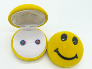 Smiley face jewelry box with colorful earrings inside on a white background